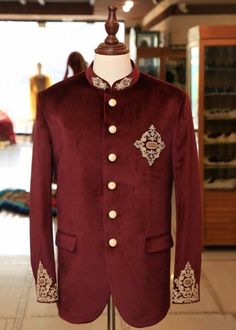 This item is made specially for you by hands with love  Item contains : Coat and pants  Fabrics :   Premium luxury velvet Colours :  Maroon coat & Cream trousers  Style and Designs :  Suit has mandarin collar and long sleeves with a full button placket symmetrical hem and multiple slits and it has hand embroidery over collar sleeves and a motif over right front chest pannel and back which is beautifully made by zardosi and golden materials are used  Trousers come with a mid rise fit and four poc Men Wedding Suit, Prince Suit, Maroon Coat, Jodhpuri Suits, Designer Tuxedo, Grooms Men, Suit For Wedding, Prince Coat, Groom Dress Men