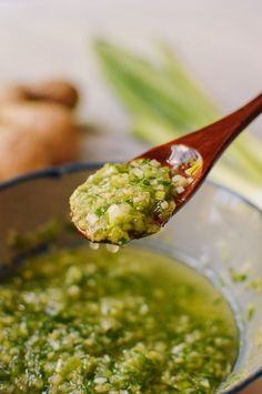 a spoon full of green sauce with celery