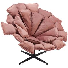 a pink chair that is sitting on a black metal base and has many pillows in it