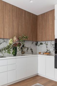 a kitchen with marble counter tops and wooden cabinets