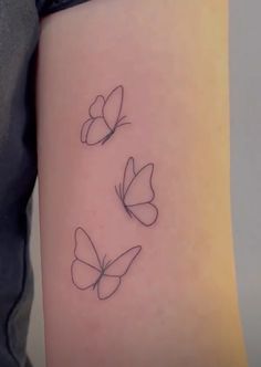 three butterflies tattoo on the right thigh