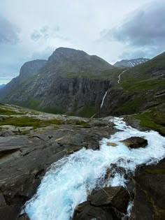 a mountain stream running between two large rocks