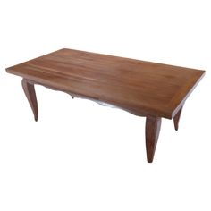 a wooden table sitting on top of a white floor