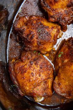 three pieces of cooked chicken in a slow cooker