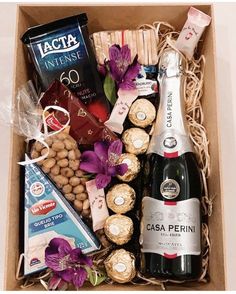 a box filled with wine, nuts and chocolates