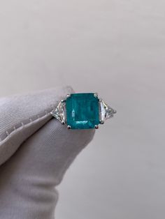 Paraiba Tourmaline Ring, Paraiba Engagement Ring, 925 Sterling Silver, Anniversary Ring, Wedding Ring, Bridal Vintage Ring, Gift For Women Handmade ring. Stone : Lab Paraiba  Gemstone Cut : Octagon Cut Stone Size : 8mm×10mm Side Stone : Cubic Zirconia Metal  : 925 Sterling Silver Plating:  Platinum Plated , Rose Gold Plated , Gold Plated. Personalization:10K/14K/24K/GOLD/SILVER/PLATINUM/ROSE-GOLD/WHITE GOLD. (Contact me)  All items come in a beautiful jewelry box.  Since all out Jewelry is Handm Luxury Rectangular Tourmaline Rings, Luxury Multi-stone Topaz Engagement Ring, Trillion Cut Gemstone Rings In White Gold, White Gold Rings With Trillion Cut Gemstone, White Gold Trillion Cut Gemstone Rings, Trillion Cut Emerald Ring In White Gold, White Gold Trillion Cut Emerald Rings, Gia Certified Trillion Cut Emerald Ring For Anniversary, Gia Certified Trillion Cut Emerald Rings