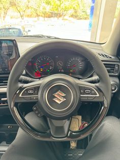 the interior of a car with steering wheel, dashboard and dash board showing various gauges