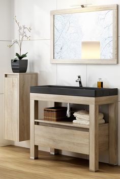 a bathroom with a sink, mirror and wooden cabinet in it's center area