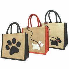 three bags with dog prints on them and one has a cat's paw printed on it