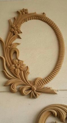 an intricately carved wooden frame hangs on the wall