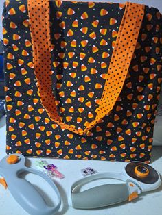 an orange and black bag with candy on it