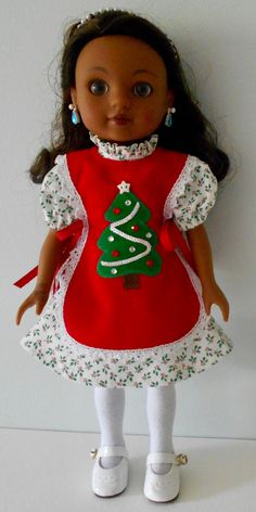 an american girl doll wearing a red christmas dress