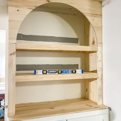 the shelves are made out of wood and have tape on them