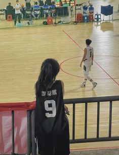 a person standing in front of a basketball court