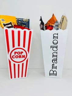 two popcorn bags with the words pop corn and candy bar in them sitting next to each other