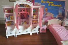 there is a doll house with furniture and bed in the room on the wooden floor