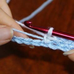 someone crocheting the ends of a piece of yarn