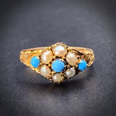 "Victorians adored turquoise, and loved to implement the stone in jewelry; it became a symbol of good luck, and was often gifted to represent fondness and love.  Traditionally many cultures associate turquoise with warding off of the \"evil eye!\" The Forget-Me-Not motif was also highly popular during the era and was included on jewels and trinkets given as tokens of affection as well as on mourning jewelry. A darling little forget-me-not bloom graces the top of this English ring from the Victorian era. Fashioned of 12 karat yellow gold, with an engraved shank, the stones are bezel set in the traditional pave' style. A wonderful eye-catching piece, she is fully hallmarked for the year 1900. Perfect for anyone who treasures the sentimental jewels popular during the infamous period of histor Fine Jewelry Gold Turquoise Multi-stone Ring, Antique Yellow Gold Turquoise Ring Gift, Antique Turquoise Ring In Yellow Gold For Gift, Heirloom Turquoise Rings Hallmarked, Heirloom Hallmarked Yellow Gold Turquoise Ring, Hallmarked Turquoise Yellow Gold Ring For Wedding, Victorian Turquoise Jewelry For Anniversary, Hallmarked Yellow Gold Turquoise Ring For Wedding, Turquoise Victorian Jewelry For Anniversary