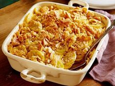 a casserole dish with nuts in it on a table next to a plate