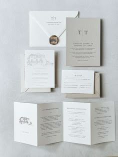 the wedding stationery is laid out on top of each other