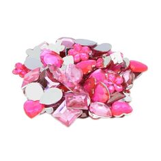 pink and silver hearts are scattered on a white surface