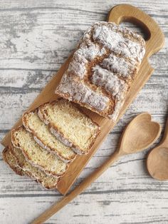 a loaf of bread sitting on top of a wooden cutting board