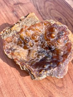 some kind of rock sitting on top of a wooden table