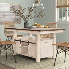 a dining room table with chairs and a bench in front of it on a rug