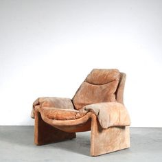 a reclining chair with a footstool in the middle