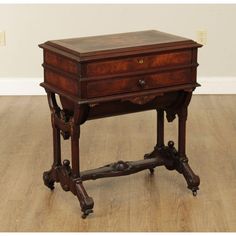 an antique wooden desk with drawers on wheels