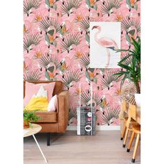 a pink flamingo wallpaper with palm leaves and flowers on it in a living room