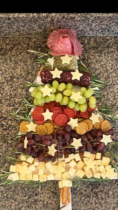 a christmas tree made out of crackers and grapes