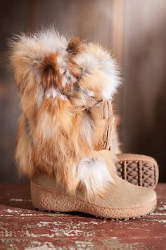 Knock ‘em dead wearing these Fox Trot fox fur boots that look fantastic with skirts, leggings or jeans. Wear them après-ski or on long winter walks to stay warm, dry and chic. These soft, fluffy boots feature durable cowhide vamps, suede ties with tassels,  and thick rubber soles for great traction Ladies Fur Boots, Chamonix I Ofy Winter Boots Fupe, Fur Boots Nordstrom, Luxury Faux Fur Winter Boots, Luxurious Boots With Faux Fur Lining, Luxury Casual Boots With Faux Fur Lining, Luxury Boots With Leather Footbed And Medium Width, Luxury Sheepskin Boots With Faux Fur Lining, Womens Fur Lined Heel Boots