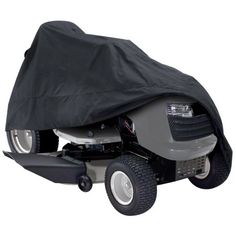 a lawn mower covered with a black cover