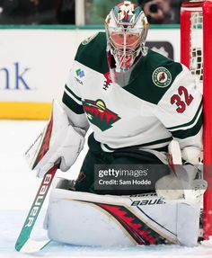 the minnesota wild goalie sits on the ice during an exhibition game against the chicago black hawks