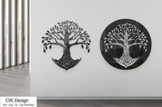 two metal wall hangings with trees on them