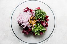 a glass bowl filled with different types of food on top of a white countertop