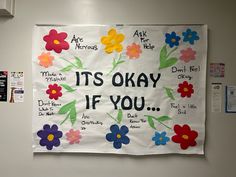 a bulletin board with flowers on it and the words its okay if you written in different languages