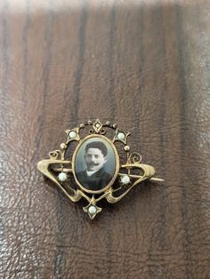 "Vintage Edwardian Portrait Brooch/pin, Sweetheart Brooch, Love Token, Mourning Pin, Gold Filled with Pearls, Tinted Photo of a Young Man This brooch measures approximately 1.5 x 1.25 inches. The metal is not marked, but it looks like it could be gold filled. It is signed \"SD.\" The photo frame is an art nouveau design that has tiny pearls. The photo in the brooch frame is the face of a young man. The man has a heavy mustache,  and the image has been tinted. The brooch closure on back is a foldover c clasp with a hinged pin.  Ships only to US  Sold as is  No Refunds or Exchanges  NYW23" Brooch Frame, Men's Brooch, Love Token, Art Nouveau Design, Gifts For My Sister, Brooch Pin, Photo Frame, The Face, Art Nouveau