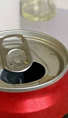 an open can of soda sitting on top of a table