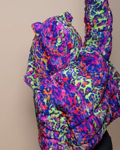 Women's Hooded Puffer Jacket - Classic This colorful animal print puffer jacket in faux fur for women is the ultimate playful attire. Featuring a bold neon animal print and cozy hood with ears, you'll be the showstopper anywhere and everywhere you prowl this Fall-Winter! Whether it's running errands around town, hitting the slopes, or as nighttime festival fashion, this cruelty-free vegan fashion jacket is as stylish as it is sustainable! Neon Disco Kitty Characteristics PLAYFUL • DANCER • CONFI Multicolor Hooded Puffer Jacket, Neon Disco, Neon Animal Print, Puffer Jackets For Women, Colorful Animal Print, Hooded Puffer Jacket, Puffer Jacket Women, Classic Jacket, Unisex Jacket