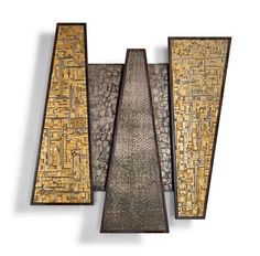 three pieces of art made out of metal and wood, each with different patterns on them