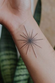 Starburst tattoo on a person's forearm, with plants in the background. Star Wrist Tattoos For Women, Star Cover Up Tattoos, Female Tattoo Ideas Unique, Star Tattoo Ideas, Orion Tattoo, Star Tattoo On Wrist, Star Outline, Star Clusters, Star Tattoo Designs