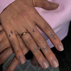 two people with matching tattoos on their fingers