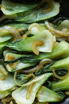 stir fry with onions and spinach in a wok on the stove or grill