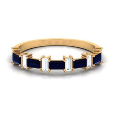 a gold ring with blue and white stones on the sides, set in 18k yellow gold