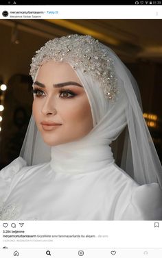 a woman wearing a white veil and headpiece with pearls on her head is looking at the camera