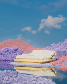 a bed sitting on top of a body of water next to purple trees and bushes