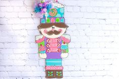 a wooden cutout of a nutcracker on a brick wall