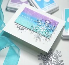 a card with snowflakes on it next to some other cards